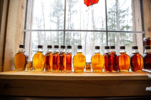 fresh maple syrup in the window of a sugar shack